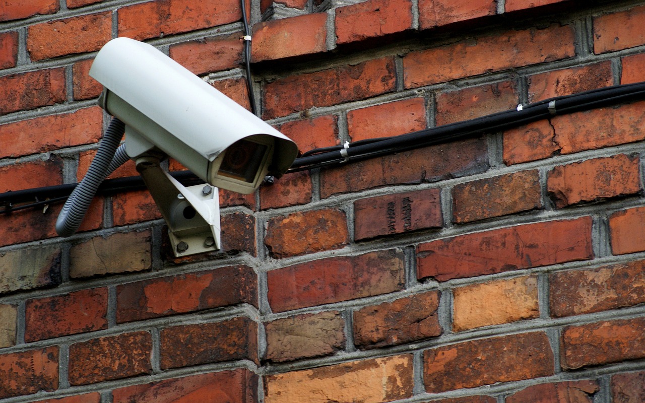 A security camera mounted on a brick wall