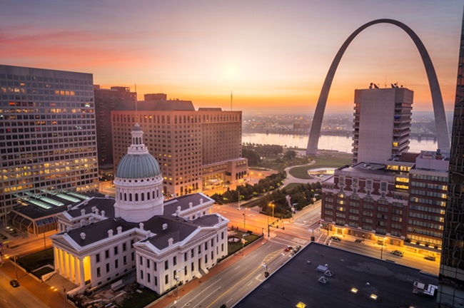 St. Louis, Missouri, USA downtown cityscape with the arch and courthouse at dusk.