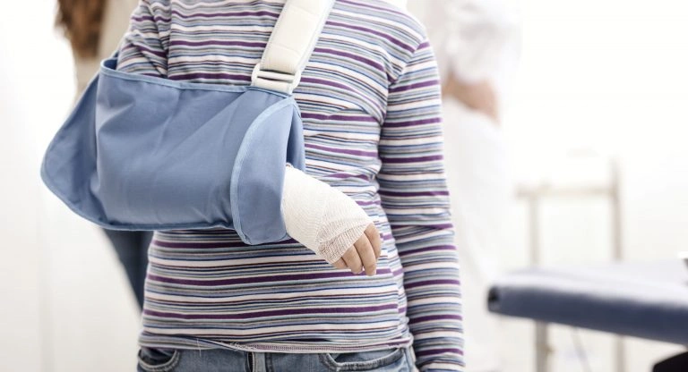 Young girl wearing an arm sling after suffering injuries in a St. Louis pedestrian accident involving a motor vehicle.