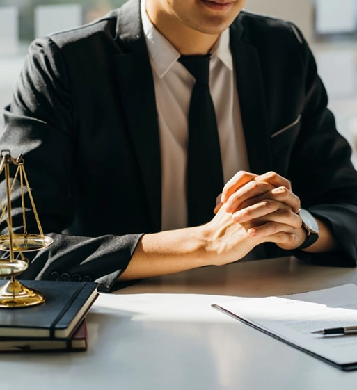 A persona injury attorney with legal documents on a desk having a consultation with a client.
