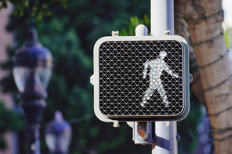 Illuminated pedestrian crossing signal at a St. Louis intersection designed to improve crosswalk safety and traffic awareness.